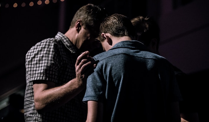 men touching each other's foreheads