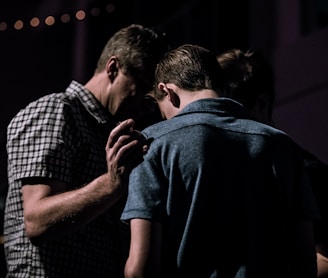 men touching each other's foreheads