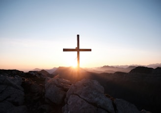 brown cross on brown rock during daytime