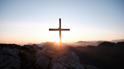 brown cross on brown rock during daytime